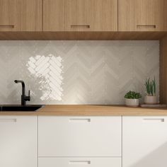 a kitchen with white cabinets and wooden counter tops, along with a black faucet