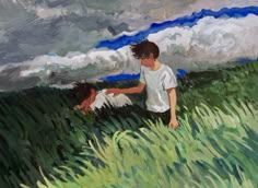 two children are playing in the grass under a cloudy sky