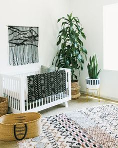 a white crib in a room with plants and rugs