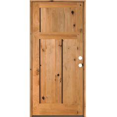 a wooden door with two round knobs on the front and side paneled doors