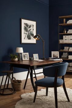 an office with blue walls and wooden floors