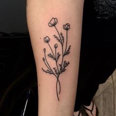 a woman's arm with a flower tattoo on the left side of her body