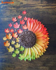 an arrangement of colorful paper flowers on a wooden table