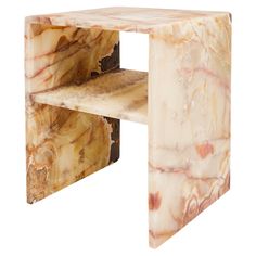 a marbled side table with two shelves