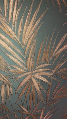 an image of palm leaves on a blue wallpapered room with brown and tan accents