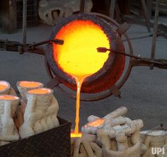 an orange substance is pouring out of a metal pot