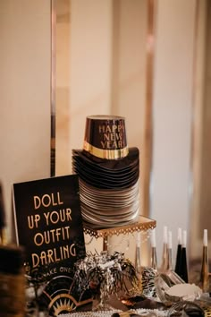 a table topped with lots of different types of plates and silverware next to a sign that says doll up your outfit daring