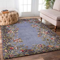 a living room with a couch and rug on the floor