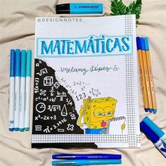 some pens and pencils are laying next to a book with the title'matenticas'written on it