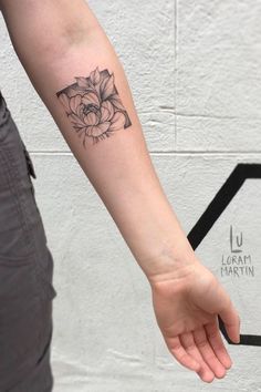 a woman's arm with a flower tattoo on the left side of her arm