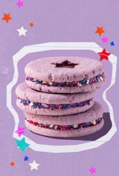 three cookies with sprinkles stacked on top of each other in front of stars