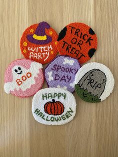 six embroidered halloween patches on a wooden surface