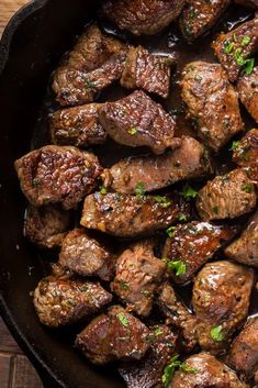 some meat is being cooked in a skillet