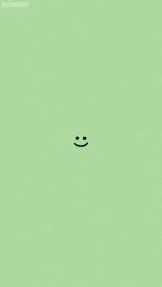 a green background with a smiley face drawn on the bottom right corner and two black dots in the middle