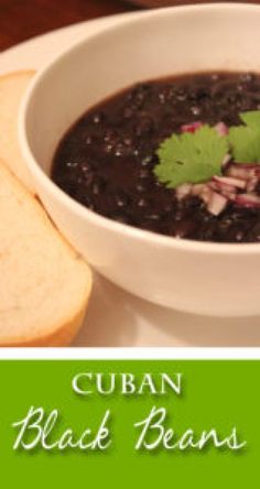 a white bowl filled with black beans and garnished with cilantro leaves