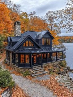 this is an image of a house in the fall with leaves on the ground and trees around it