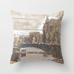 a pillow with a painting on it that looks like an old city street and bridge