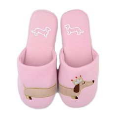 a pair of pink slippers with a dachshund on them