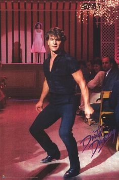 a man in black shirt and jeans dancing on stage