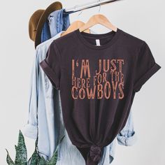 I'm Just Here For The Cowboys Shirt, Cowgirl Shirt UNISEX T-Shirt Bella+Canvas 3001 .: Black, Brown, Soft Cream, Red: 100% cotton    Dark Grey Heather: 52% cotton, 48% polyester .: Light fabric (4.2 oz/yd²) .: Runs true to size ❤️ Returns & exchanges I don't accept returns, exchanges, or cancellations All sales are final. Thank you for supporting our small business! Western Rodeo Shirts, Western Cricket Shirts, Cowboy Shirts Women, Western Vinyl Shirts, Country Shirt Ideas Vinyl, Country Shirts For Women, Western Tshirt Designs, Country Girl Tshirts, Rodeo Clothes