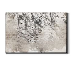 an abstract painting with leaves and branches in grey tones on a white wall above it