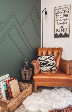 a brown leather chair sitting on top of a rug next to a wooden box filled with books