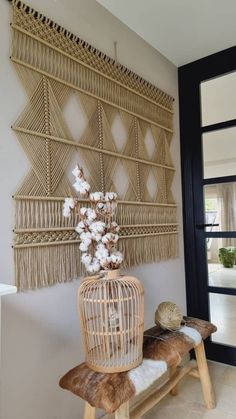 a wooden bench sitting next to a wall covered in wickers and white flowers