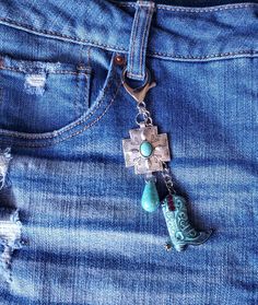 a pair of jeans with charms attached to them