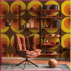 an orange chair sitting in front of a book shelf