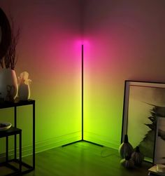 a room with a green floor and a pink light on the wall next to it