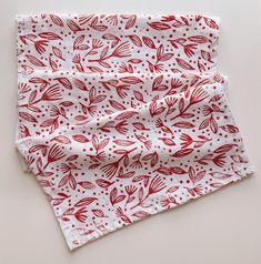 a red and white bandana with leaves on it