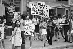 black and white photograph of people holding protest signs