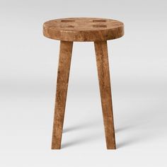 a small wooden table sitting on top of a white floor