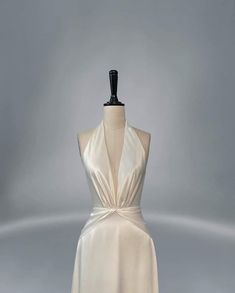 a white dress on a mannequin stand