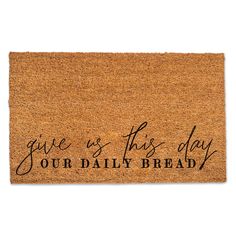 a door mat with the words give us this day our daily bread written on it