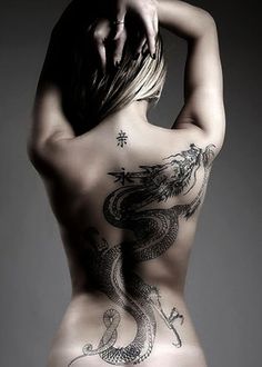 the back of a woman with tattoos on her body