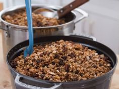 two pans filled with granola sitting on top of a counter