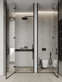 a modern bathroom with glass walls and black accents