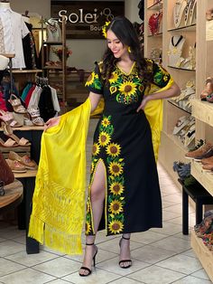 This Beautiful Mexican Sunflower Dress is the perfect dress for a special event or Mexican Fiesta. It reflects the Mexican culture through its unique design and vibrant colors. It has ties on the back for an adjustable fit and is embroidered by Artisanal Machine by Mexican Artisans in Puebla, Mexico. It's made out of fresh Mexican cotton, is full of colorful embroidered sunflowers and has some crocheted details. Mexican Bridesmaid Dresses, Blue Dresses For Women, Mexican Sunflower, Traditional Mexican Dress, Mexican Theme, Sunflower Dress, Bohemian Style Dresses, Mexican Dress, Latina Fashion