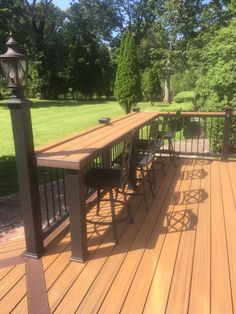 a wooden deck with chairs and table on it