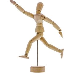 a wooden mannequin is standing on a stand with his arms spread out to the side