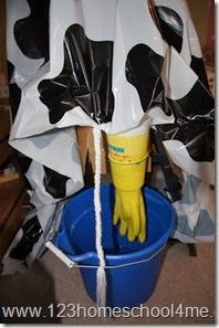 a bucket filled with black and white cow paper