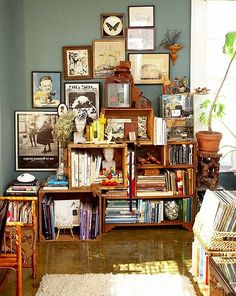 a living room filled with lots of books and pictures