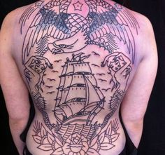 the back of a woman's body with an eagle and ship tattoo on it