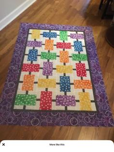 a colorful quilt on the floor in a room