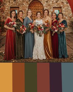 a group of women standing next to each other in front of a stone building with red flowers