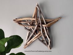 a star made out of driftwood is hanging on the wall