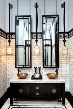 a bathroom with two sinks and mirrors in it