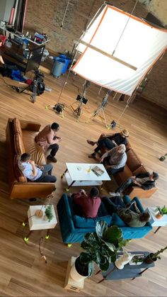 several people sitting on couches in a large room