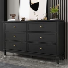 a black dresser with a mirror and vases on top of it in a room